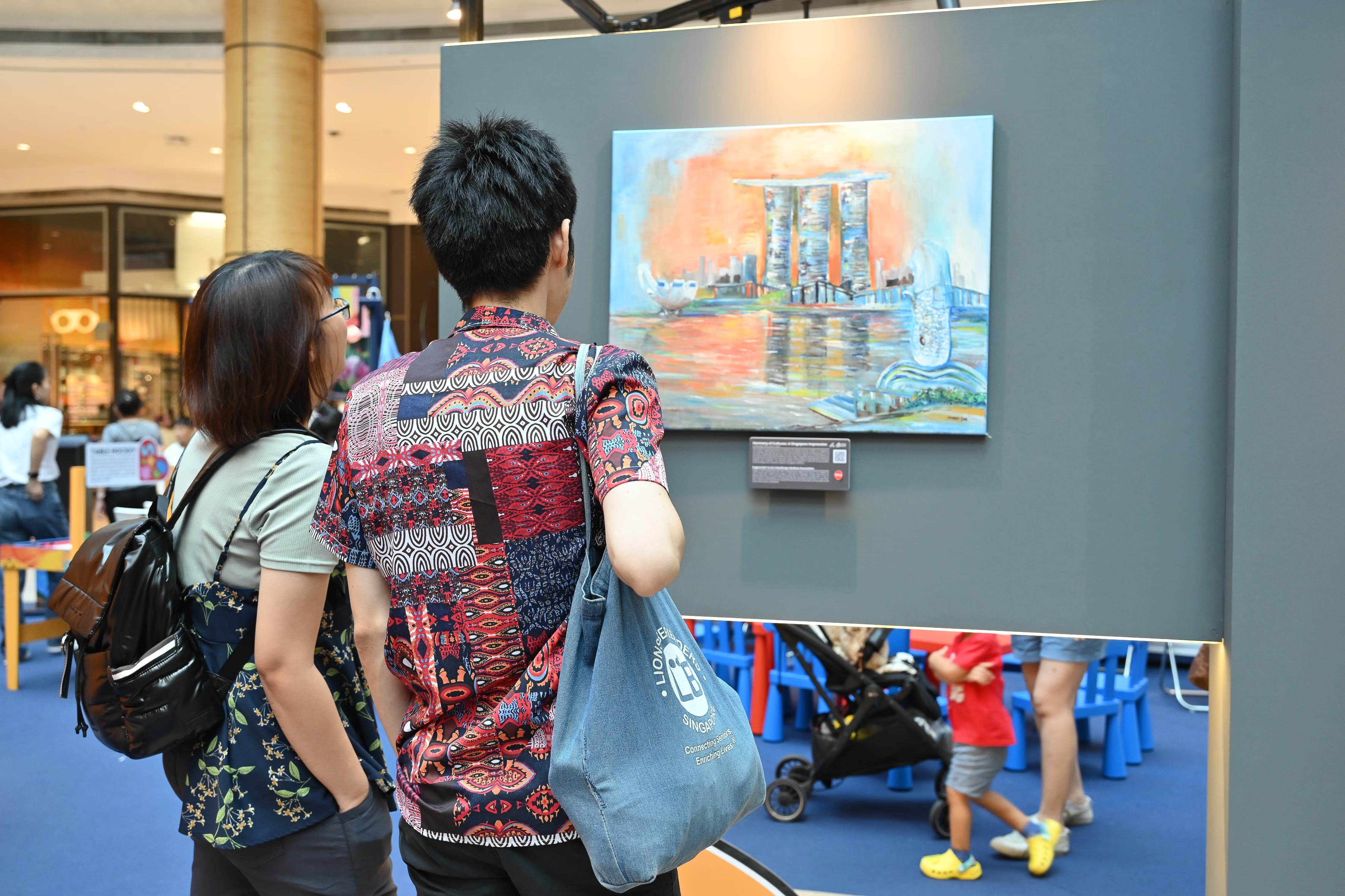 Couple admiring an artwork of Marina Bay sand and the Merlion